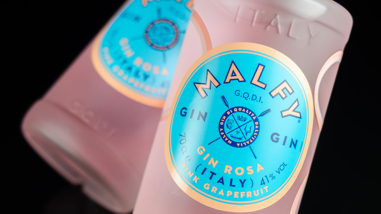 A close up shot of two bottles of Malfy Rosa Gin in a plain black background