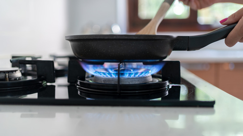 Hot pan on stove with quartz countertop