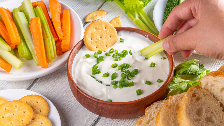 Dunking crackers and crudites into blended cottage cheese dip