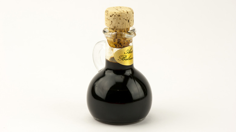Bottle of balsamic vinegar on white background