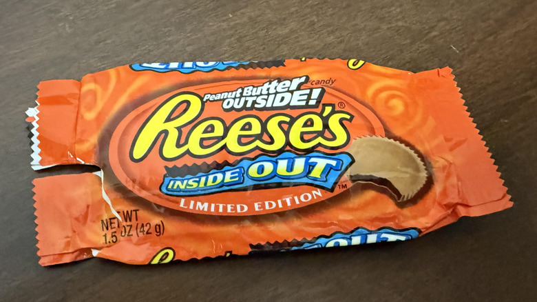 An empty Reese's Inside Out Peanut Butter cup wrapper