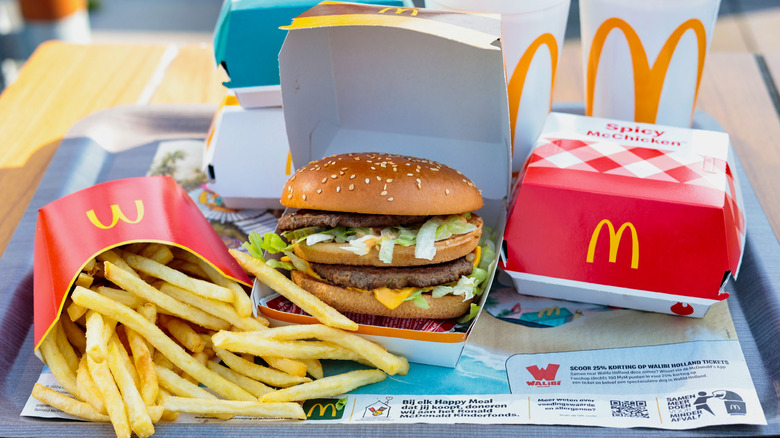 A McDonald's order featuring fries, a Big Mac, a Spicy McChicken sandwich, and two drinks