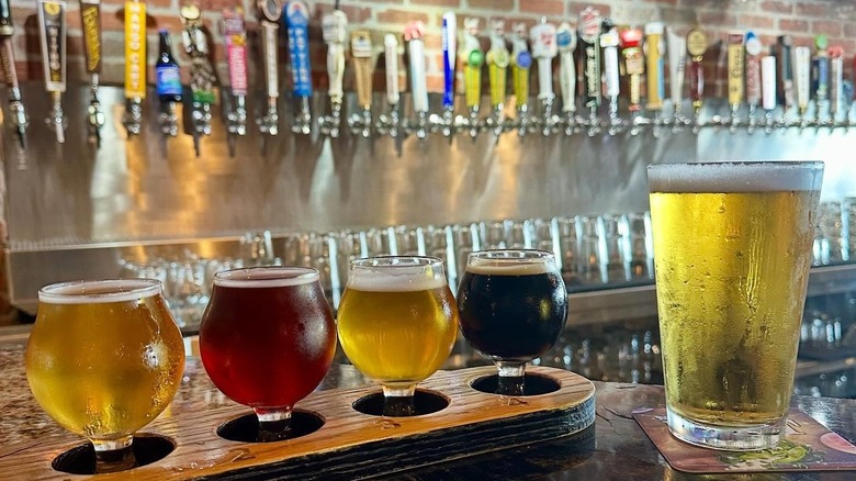Flight and a pint in front of taps at World of Beer