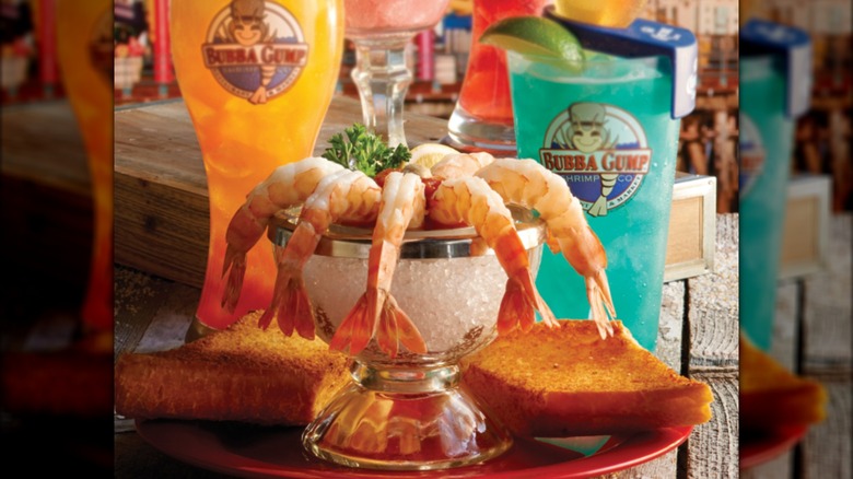 Shrimp cocktail syrup in a dish with cocktails in the background