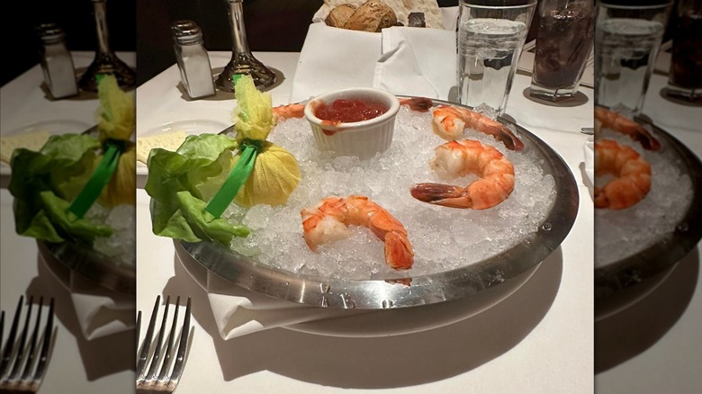 Shrimp cocktail with shrimps placed on ice next to a cocktail sauce at The Capital Grille