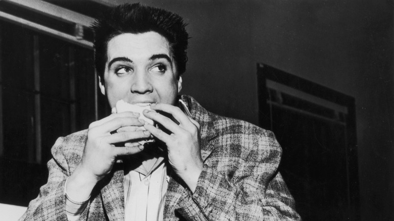 young Elvis eating a sandwich