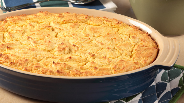 Cornbread casserole in deep blue and white baking dish.