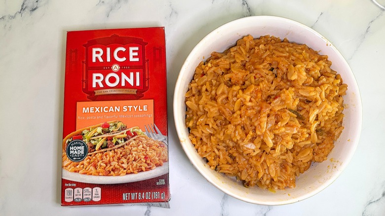 Top-down shot of bowl of Mexican Style Rice-A-Roni next to box on marble surface