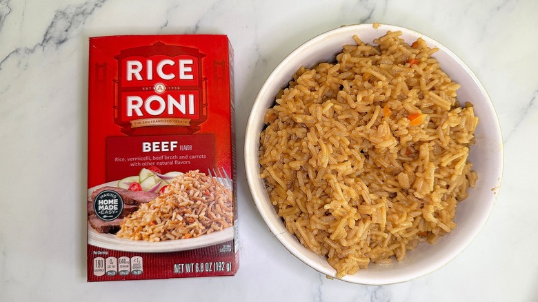 Top-down shot of bowl of Beef Rice-A-Roni next to box on marble surface