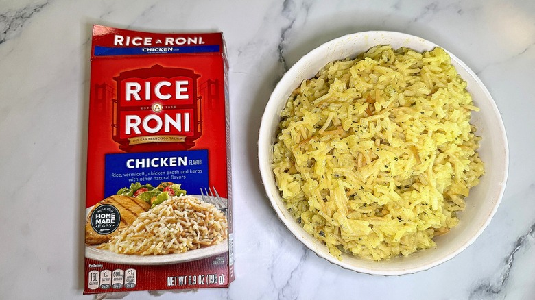 Top-down shot of bowl of Chicken Rice-A-Roni next to box on marble surface