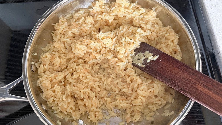 Cooking Rice Pilaf Rice-A-Roni in pan on stove