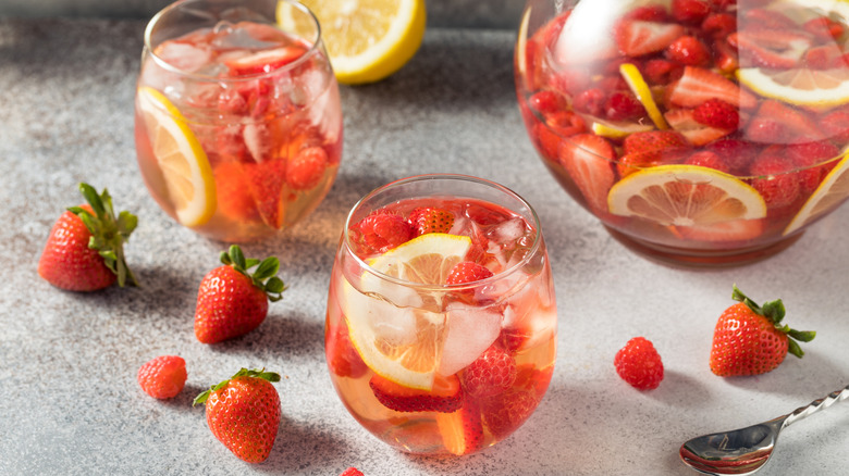 Glasses of rosé wine sangria with strawberry, lemon, and raspberry
