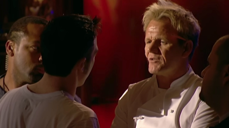 contestant in front of Gordon Ramsay and bodyguards