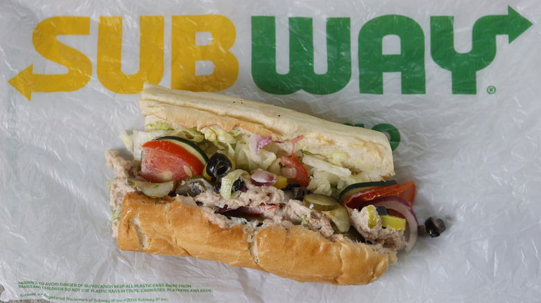 A Subway tuna sandwich on a branded wrapper