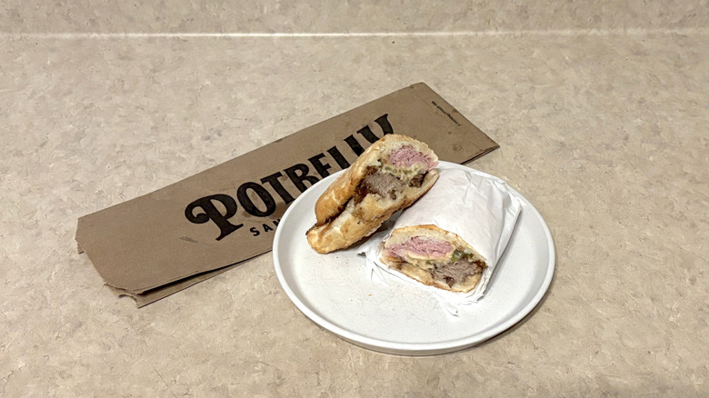 Potbelly Cubano sandwich on white plate and neutral counter.