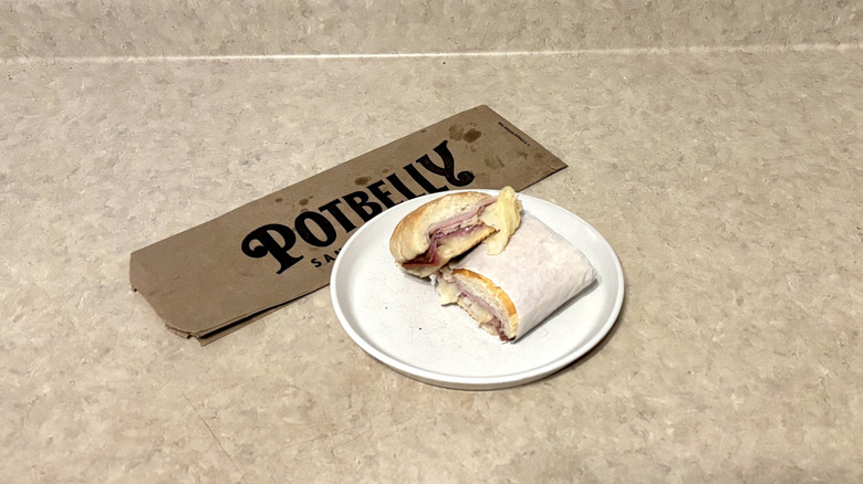 Potbelly wreck sandwich on a white plate and neutral counter.