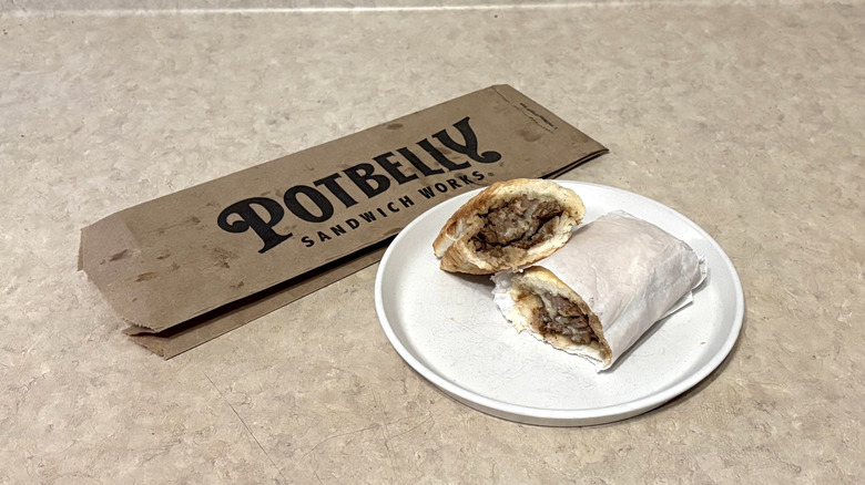 Potbelly prime rib steak sandwich on white plate and neutral counter.