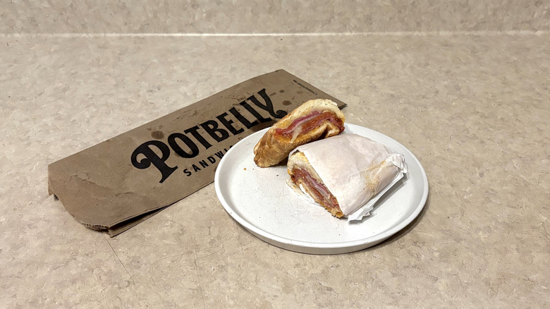 Potbelly Italian sandwich on white plate and neutral counter.