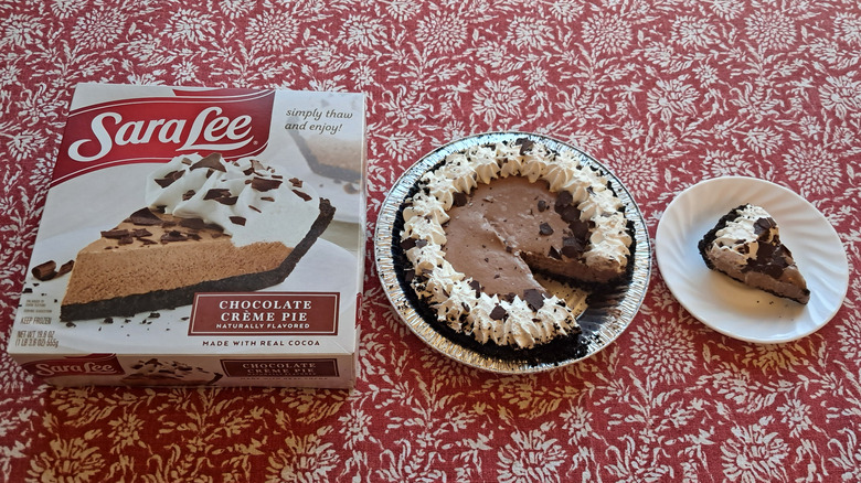 chocolate pie with single slice on plate and packaging on table