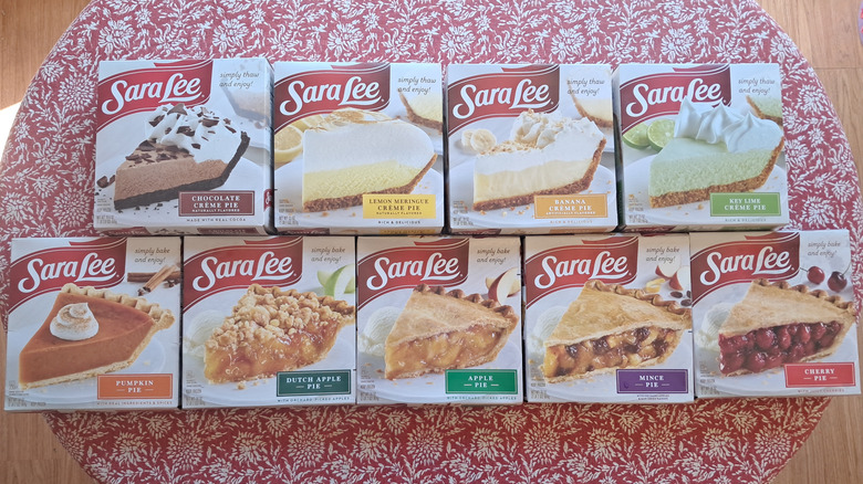 nine pies in boxes on a table