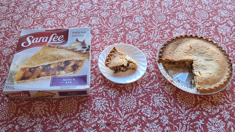 whole pie in tin next to single slice and packaging on table