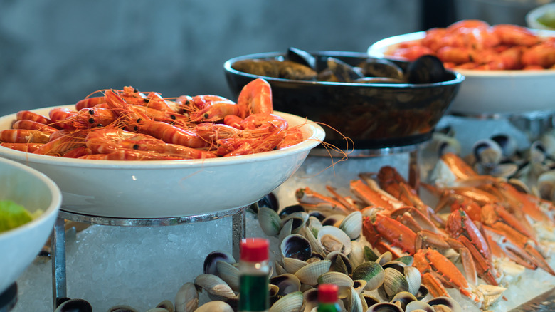Seafood buffet setup with shrimp, clams, and more
