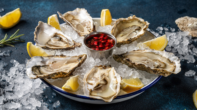 Oysters and lemon wedges on ice
