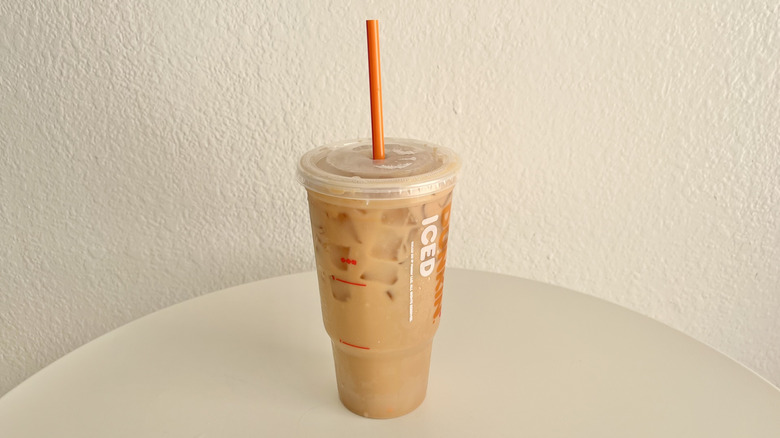 Toasted French Vanilla Iced Latte with straw and lid