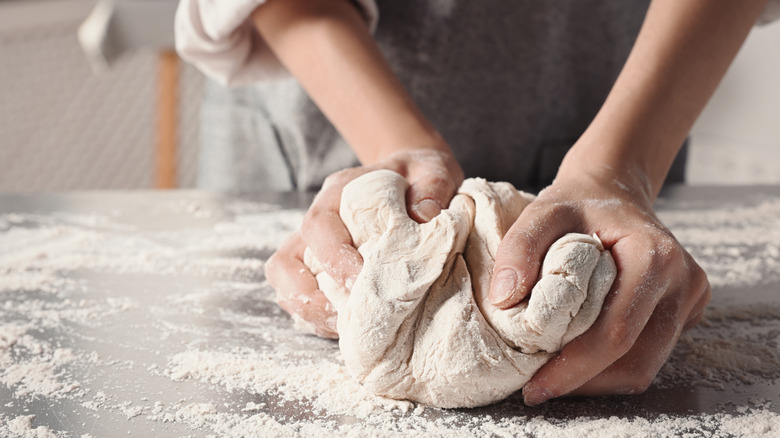 baker kneading dough