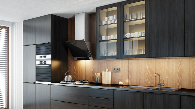 dark kitchen cabinets with a light wood backsplash