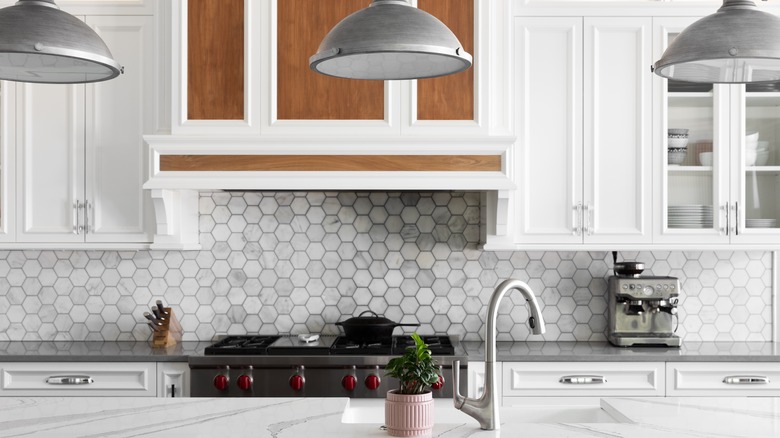 kitchen with white cabinets and gray tiled backsplash