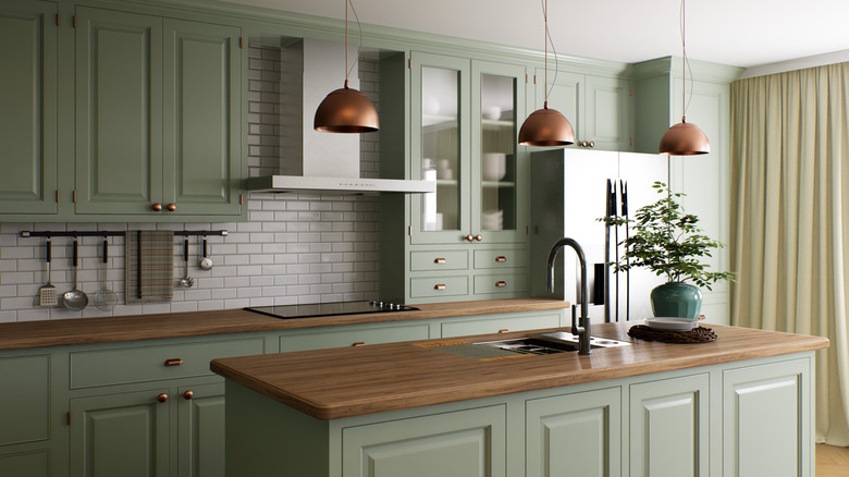 a kitchen with green cabinets