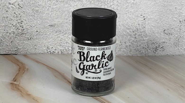 Container of Trader Joe's black garlic on table