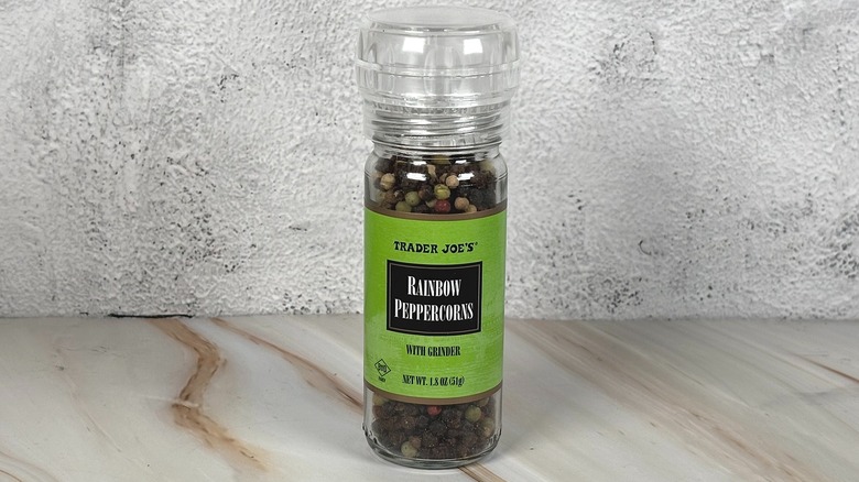Container of Trader Joe's rainbow peppercorns on table