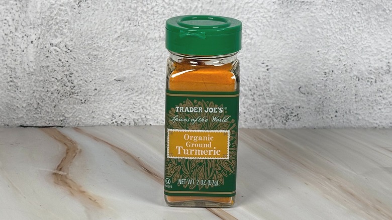 Container of Trader Joe's turmeric on table