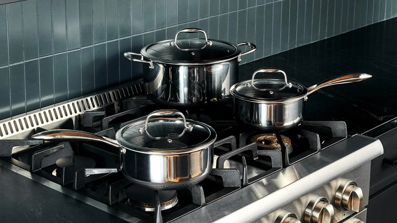 HexClad 6-piece saucepan set on gas stovetop