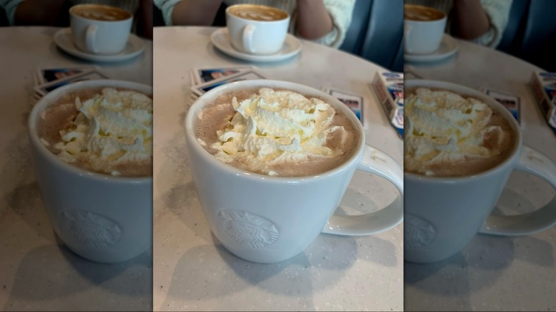Hot chocolate with whipped cream in white Starbucks mug