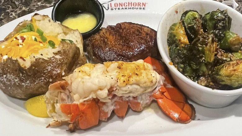 LongHorn Steakhouse lobster tail with steak and sides on white plate