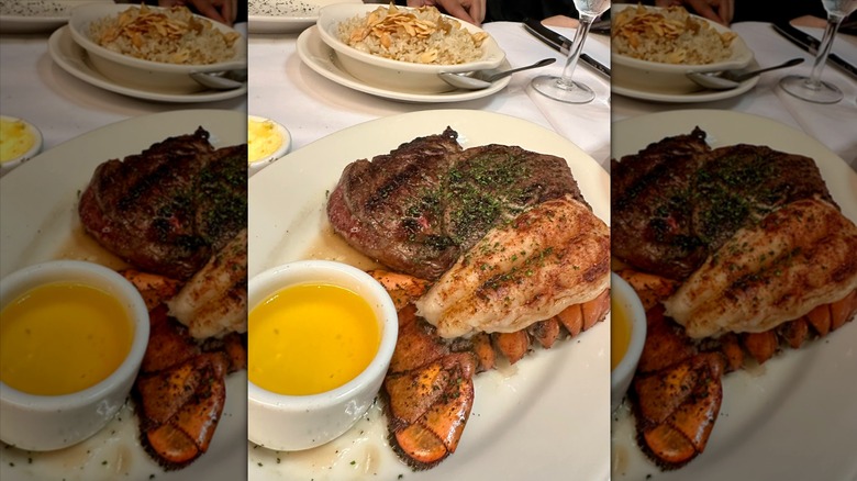 Lobster tail with steak on white plate