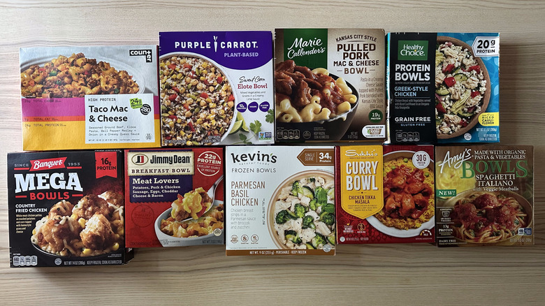Assortment of frozen meal bowls on wooden table