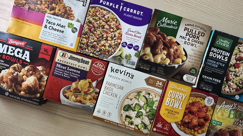 Assortment of frozen meal bowls on wooden table