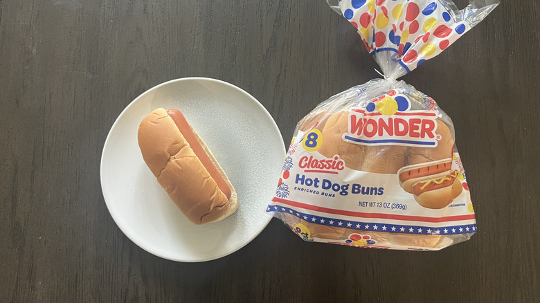 A bag of Wonder Classic Hot Dog Bun with one hot dog on a white plate