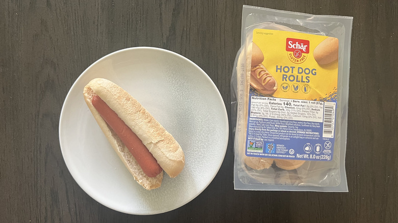 Schar Hot Dog rolls package with a hot dog on a plate