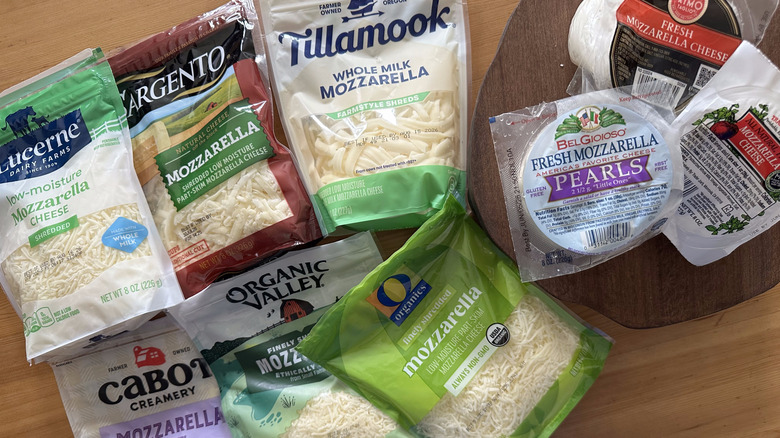 Variety of mozzarella cheeses on wooden table
