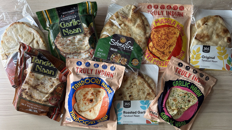 Packages of store-bought naan on wooden table