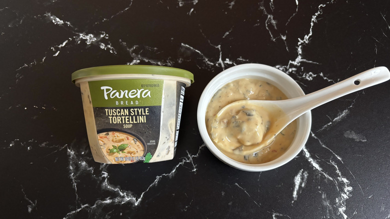 Panera Tuscan style tortellini soup container next to bowl of soup