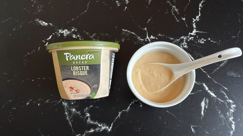 Panera lobster bisque soup container next to bowl of soup