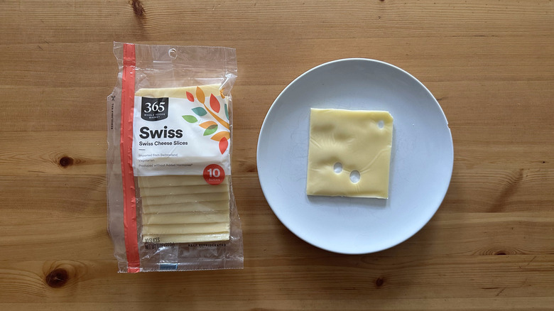 365 Swiss Cheese Slices on wooden table