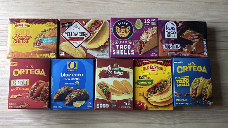 Top view of various brands of taco shell boxes arranged on wooden table