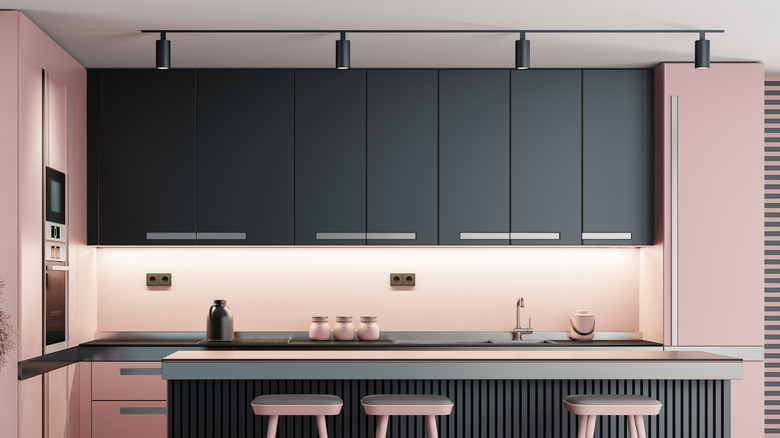 Pink kitchen with black metal cabinets and counter